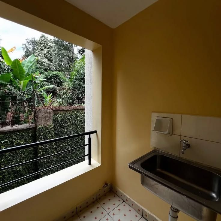 Utility area with sink and garden view